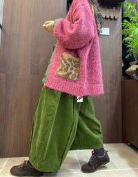 Green ribbed cuff and hem trim on pink cardigan
