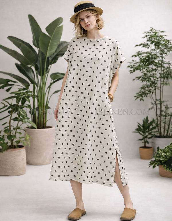 Cream polka dot midi dress with short sleeves and side slit, loose fit front view on model.