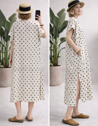 Woman wearing cream polka dot midi dress styled with straw hat and flats in a minimal indoor setting.