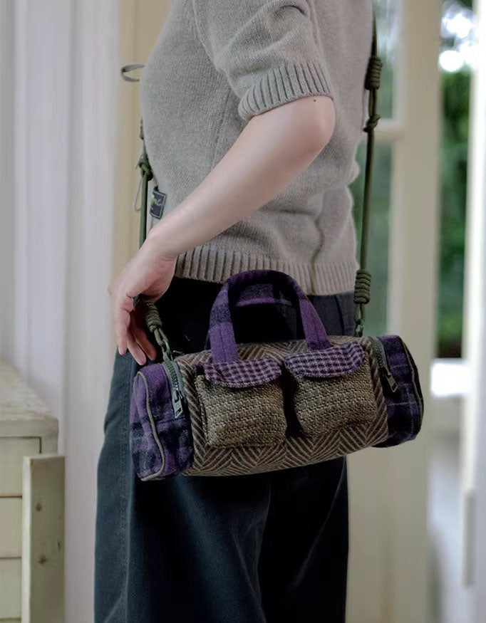Person holding a textured handbag with purple accents