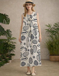 Sleeveless cream maxi dress with bold navy botanical print and loose straight fit, front view on model.