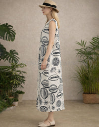 Side view of sleeveless cream printed maxi dress showing relaxed straight silhouette and ankle length.