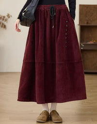 Brown women’s midi skirt with decorative button details and side pockets