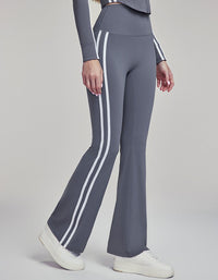 Gray pants with white stripes worn by a person on a gray background side view