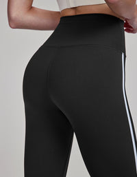 Black leggings with a white stripe on a gray background back view