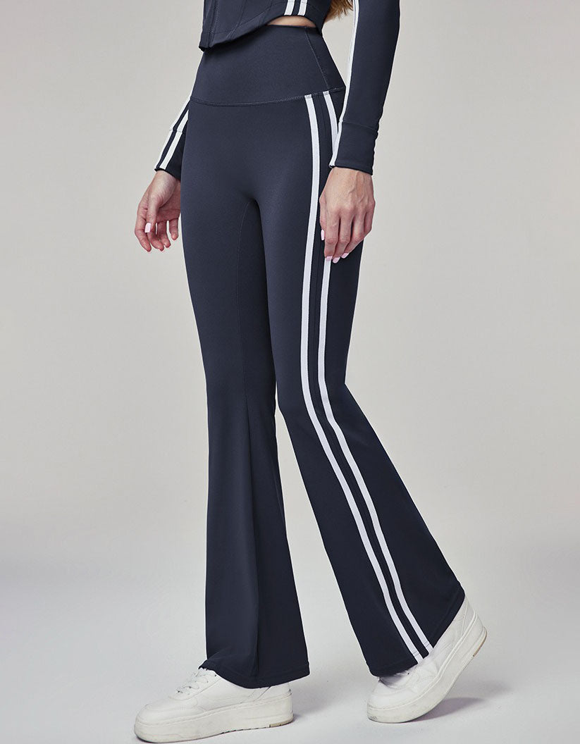 Navy blue pants with white stripes worn by a person on a gray background side view