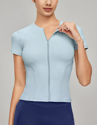 Light blue athletic top worn by a person on a gray background
