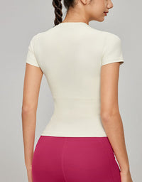 Person wearing a white top and pink pants on a gray background back view