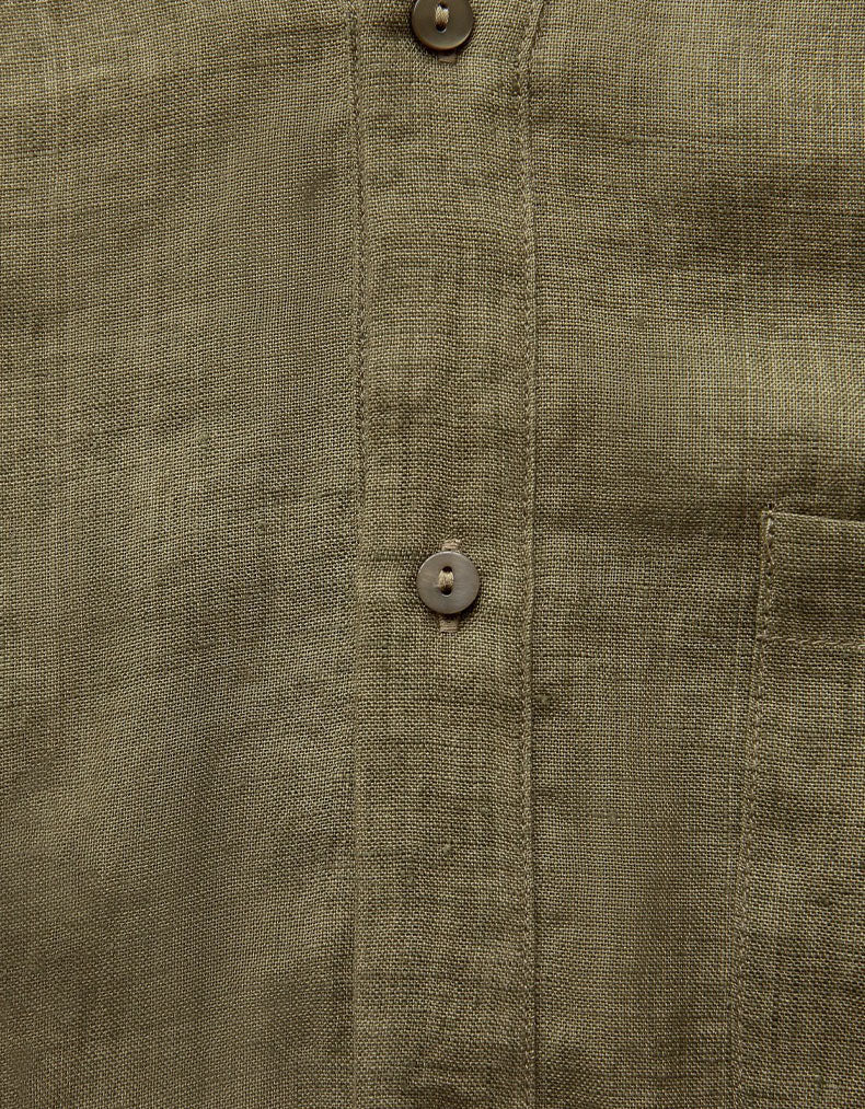 Close-up of a green shirt with button details