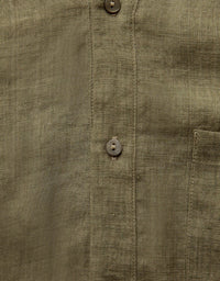 Close-up of a green shirt with button details
