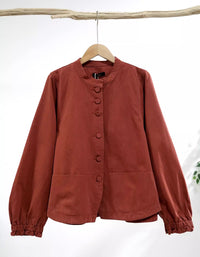 Brown button-up shirt on a wooden hanger against a white background