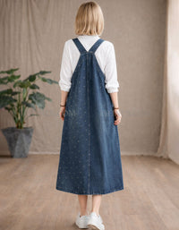 Back view of women layered denim pinafore dress with white shirt