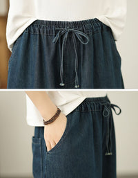 Close-up of floral embroidery and butterfly details on denim pants