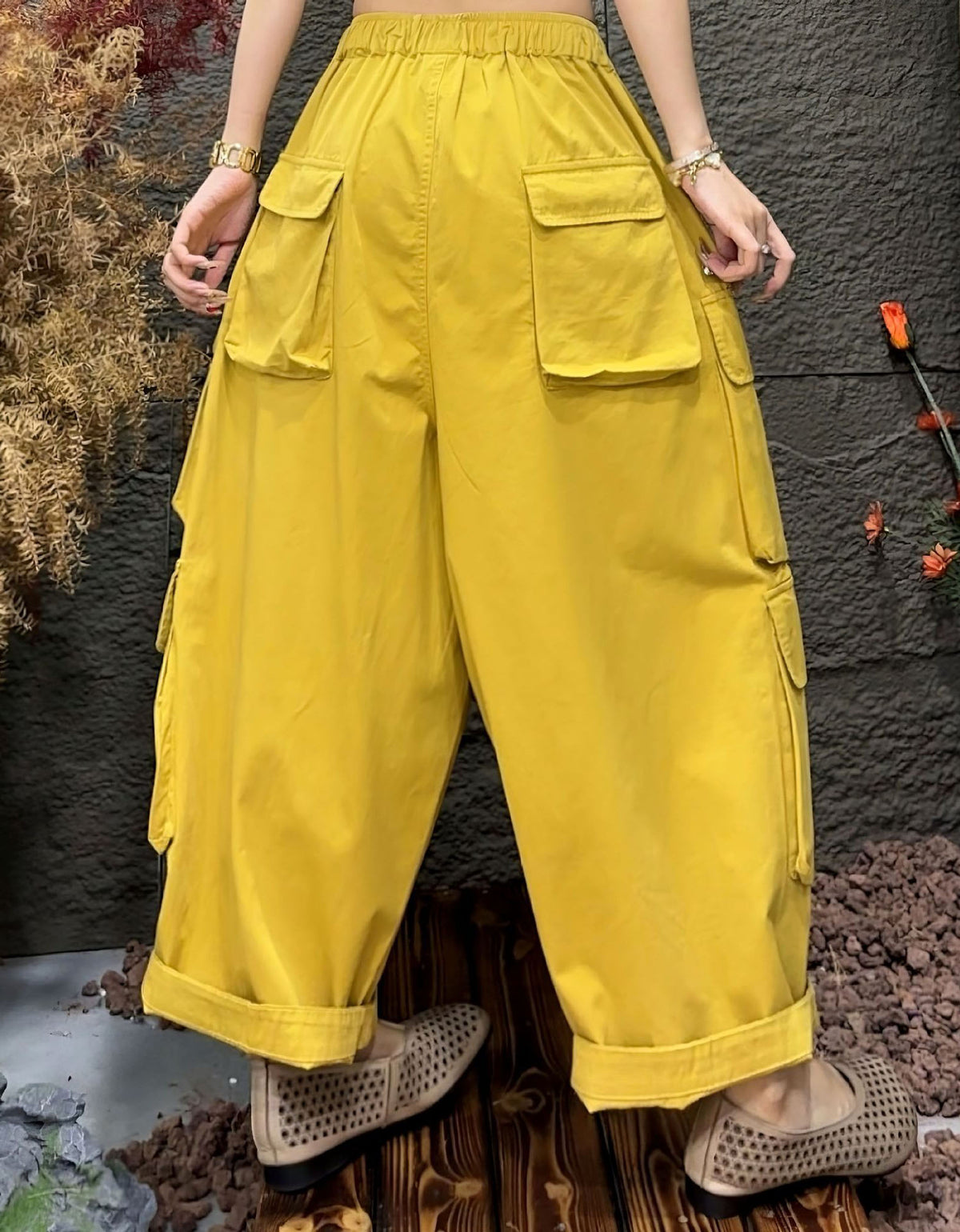 Back view of casual outfit with yellow cargo trousers and relaxed fit design