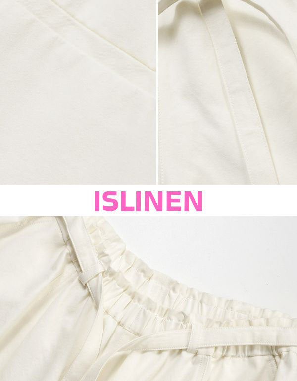 Close-up of women’s high waist beige wide leg pants with relaxed fit.