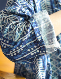 Close up tribal pattern detail on blue linen dress