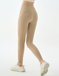 Beige leggings worn by a person on a white background