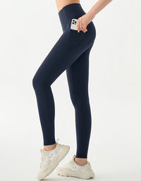 Person wearing navy leggings on a white background