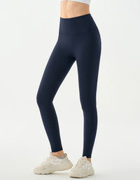 Navy blue leggings worn by a person on a white background