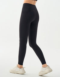 Black leggings worn by a person on a white background