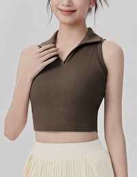 Woman wearing a brown sleeveless top against a plain background