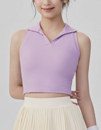 Person wearing a light purple sleeveless top with a collar on a plain background