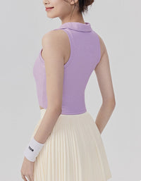 Person wearing a sleeveless purple top and beige pleated skirt on a plain background back view