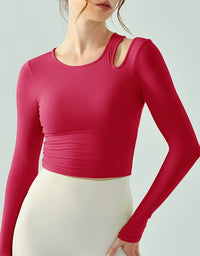 Person wearing a pink long-sleeve top against a light gray background