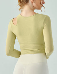 Light green long-sleeve top worn by a person on a light gray background back view