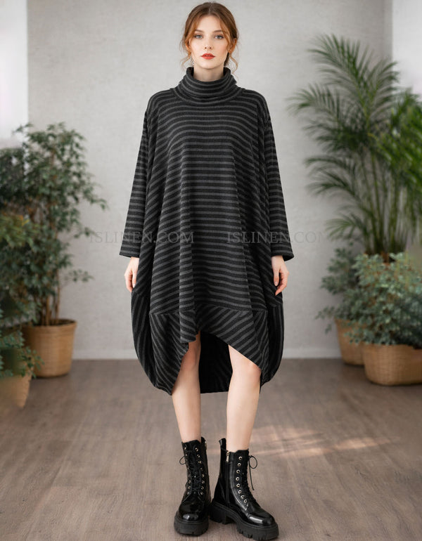 Woman wearing a black striped dress with boots in a room with plants
