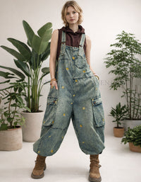 Baggy vintage wash denim overalls with wide legs and cargo pockets, front view on model.