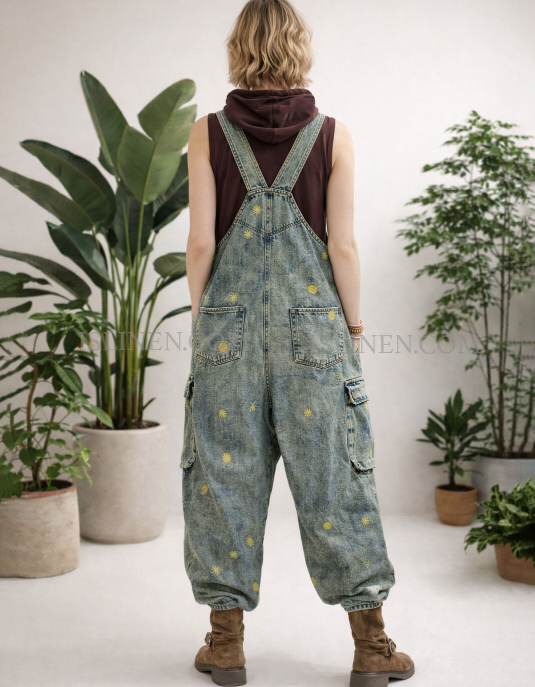 Loose fit vintage wash denim overalls with wide legs and adjustable back straps.