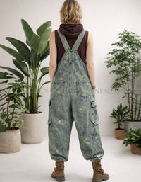 Loose fit vintage wash denim overalls with wide legs and adjustable back straps.