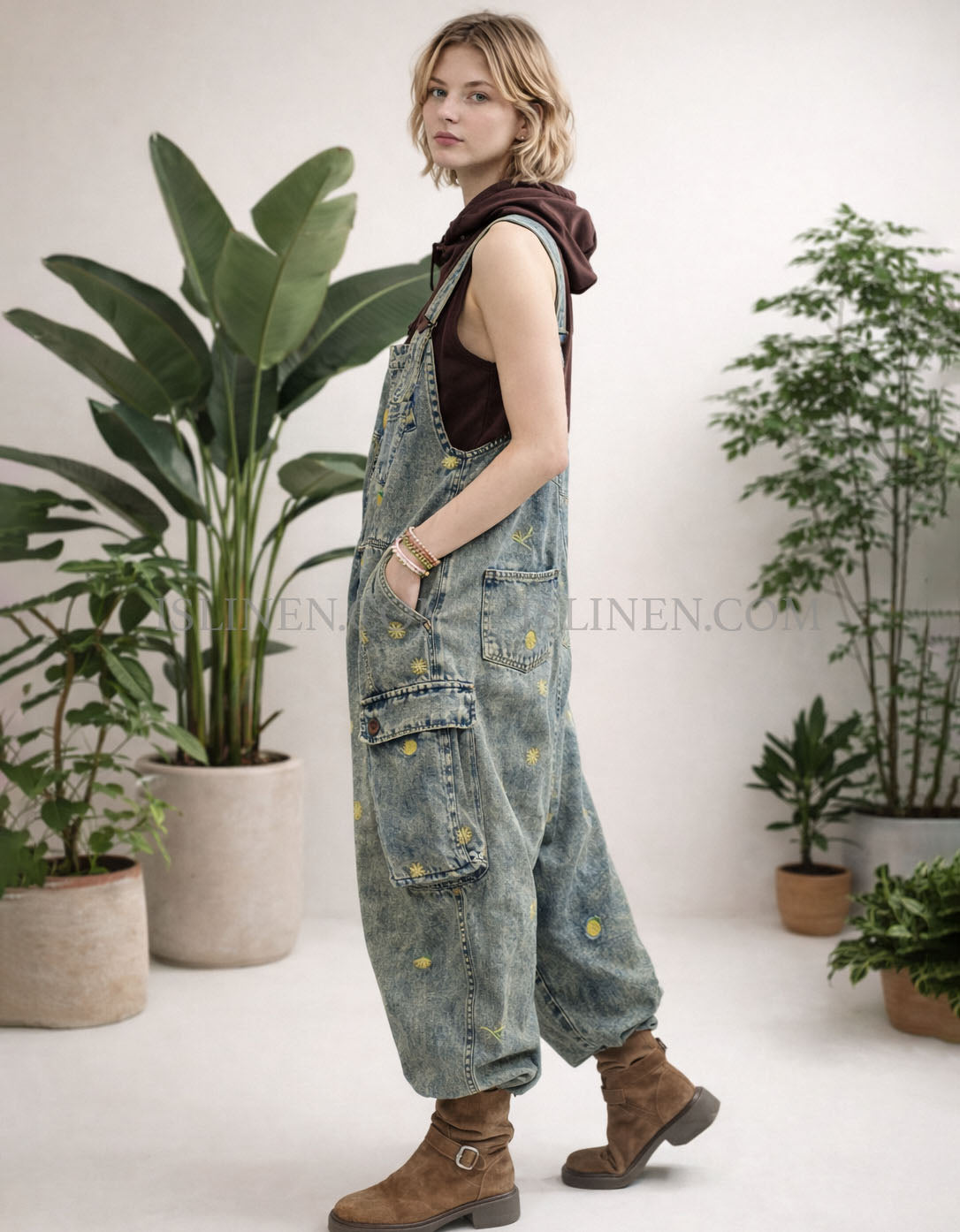 Wide leg baggy denim cargo overalls showing side pocket and relaxed fit on model.