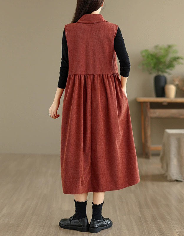 Back view of elegant brick red sleeveless midi dress styled with black inner top