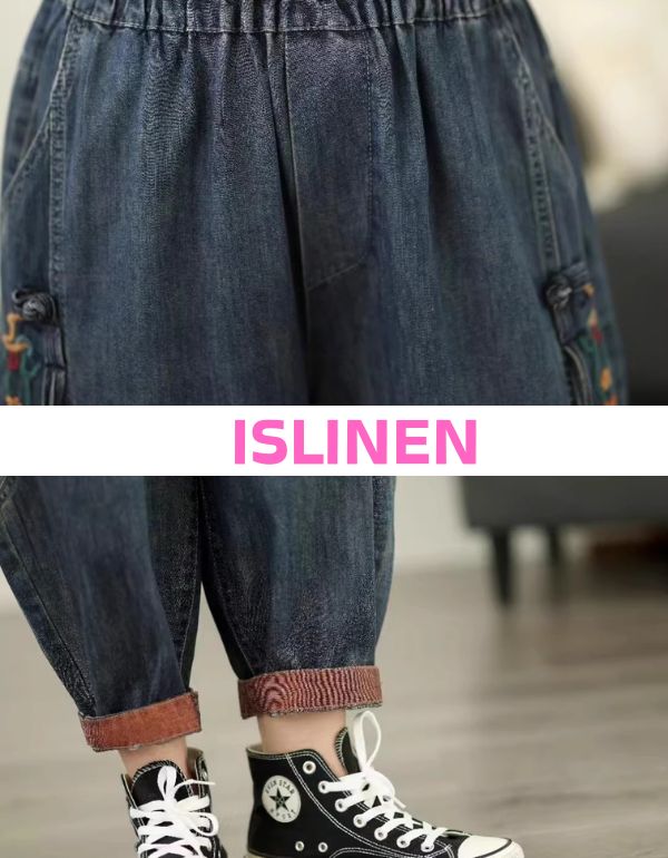 Close-up of floral embroidery on side of denim jogger pants