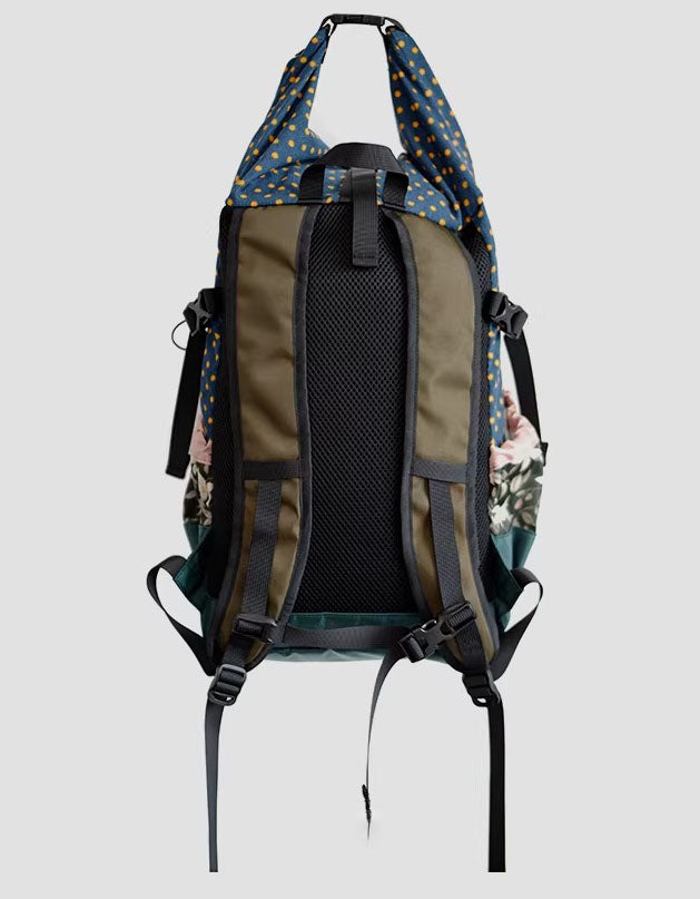 Backpack with floral pattern on a light gray background