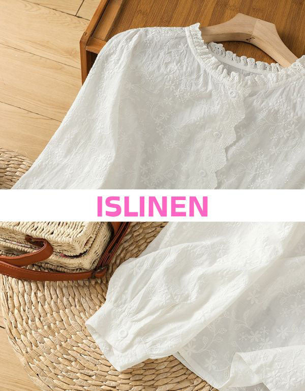 Close-up of elegant cream floral lace blouse with scalloped neckline