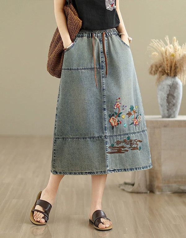 A-line denim midi skirt featuring floral embroidery details