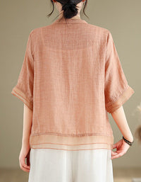 Back view of women’s embroidered linen blouse with short sleeves and button front