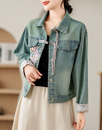 Side view of women’s denim jacket with intricate floral embroidery on the front.