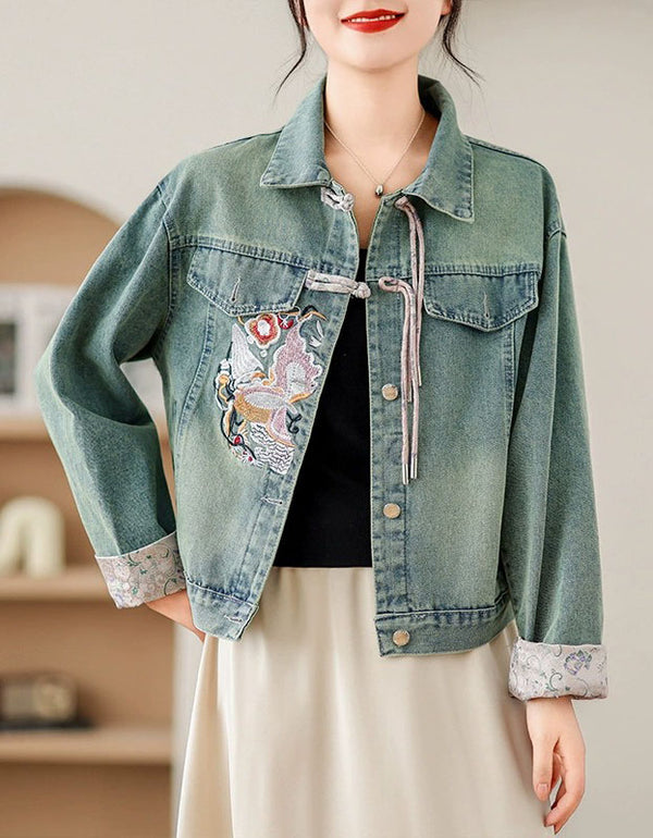 Front view of women’s embroidered denim jacket with floral design and drawstring detail