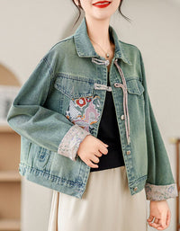 Front view of a woman wearing a stylish embroidered denim jacket with a drawstring