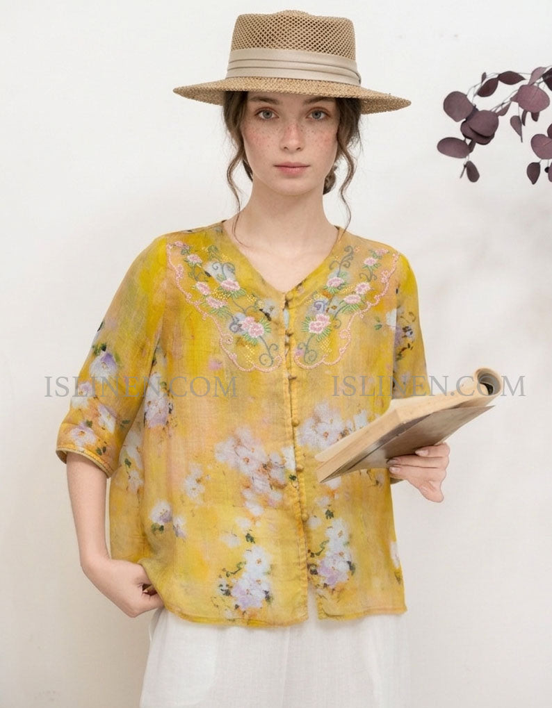 Women yellow linen blouse featuring floral embroidery and loose fit design