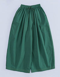 Green wide-leg pants on a light gray background