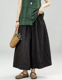 Women's vintage dark washed denim wide leg culotte pants with elastic waist and relaxed oversized fit