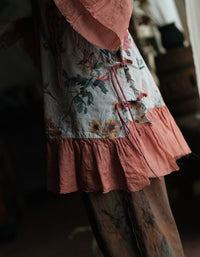 Close-up of the floral design and tie details on the linen dress