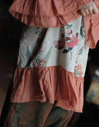 Woman wearing floral linen dress with boho accessories