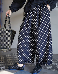 Side view of loose fit polka dot linen trousers for women