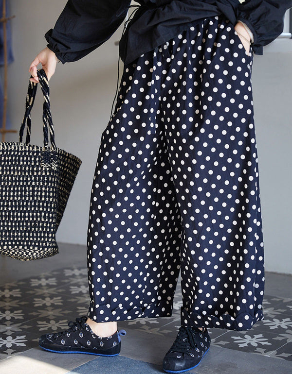 Side view of loose fit polka dot linen trousers for women